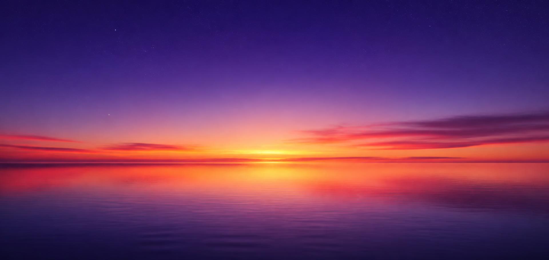 Dawn light rising over a still horizon